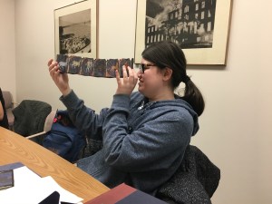 ENGL WRIT 2223 student Corrine MacLean examining a book